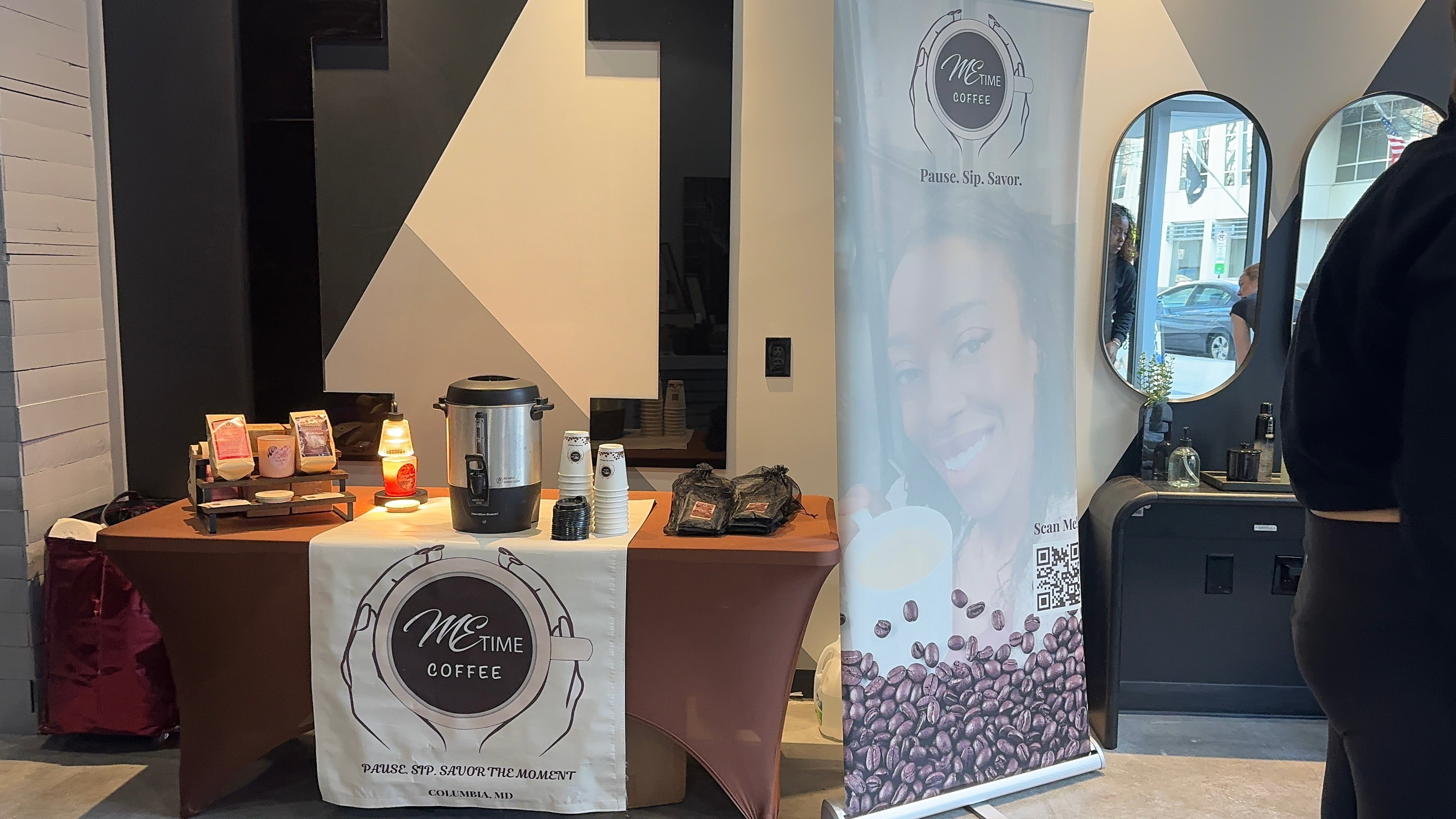 Coffee-themed event setup with branded materials and coffee beans displayed.