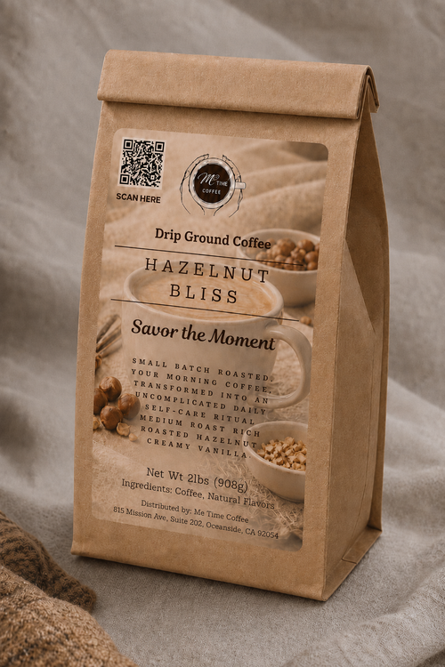 A kraft paper coffee bag labeled 'Hazelnut Bliss' by Moon Coffee, standing upright on a neutral fabric surface with a soft, textured background.