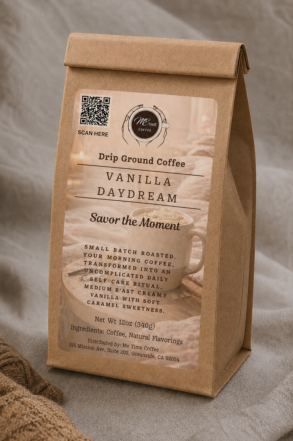 A kraft paper coffee bag labeled 'Vanilla Daydream' drip ground coffee, standing upright on a neutral textured surface with a burlap cloth at the lower left.